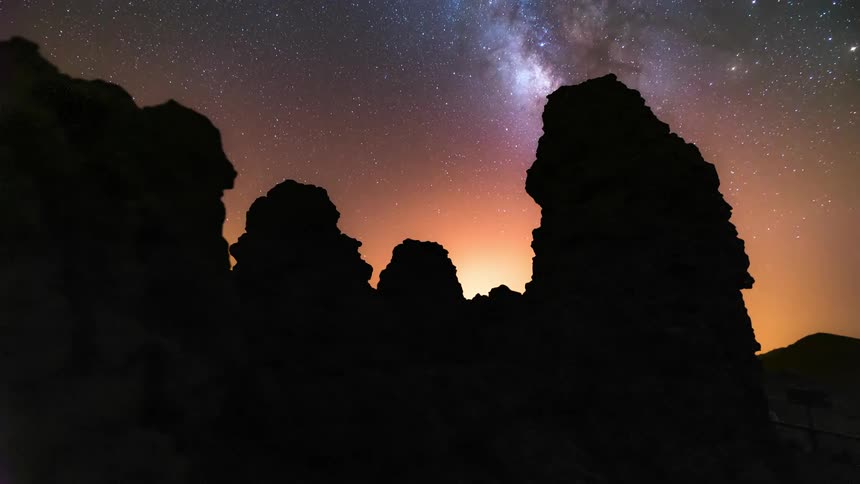 Starry sky with silhouettes of rocks and mountains