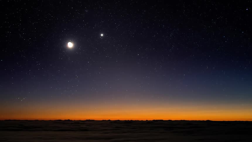 Time lapse sunset turning into night with a starry night over the landscape
