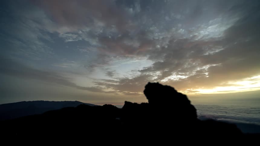 Silhouette scenery of mountains with the dawn starry sky