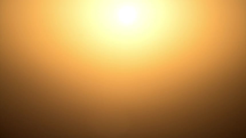 Sun rising in an orange sky