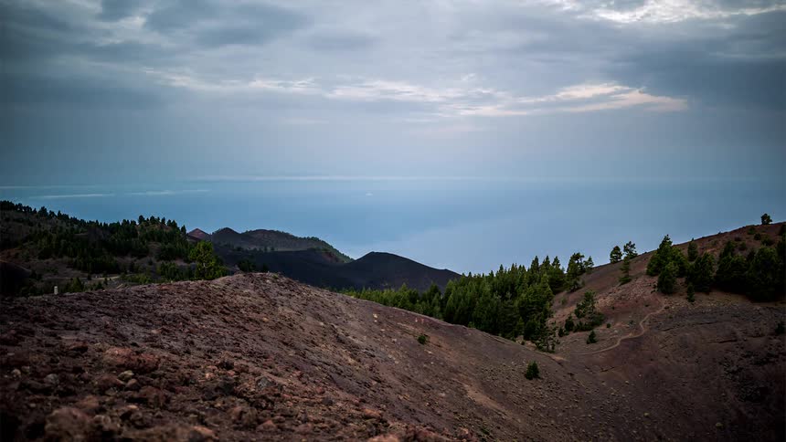 Mountainous landscape with vegetation and the dawning sky