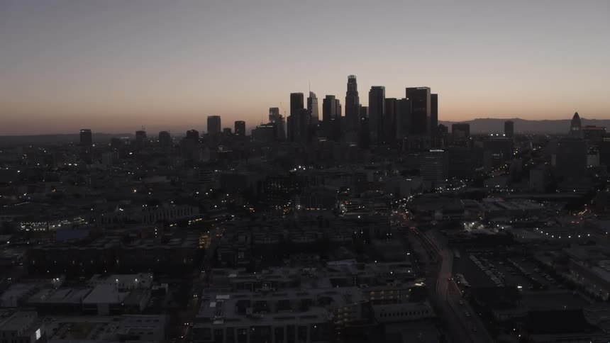 Aerial view of a large city at dusk on a clear evening