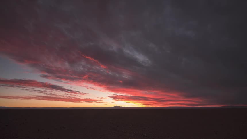 Landscape of a sky with a sunset in red tones and stormy clouds