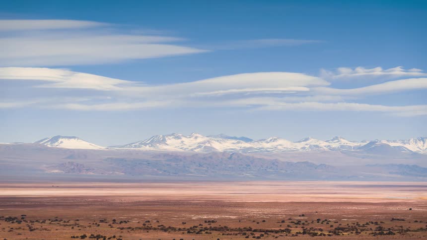 Time lapse of clouds rolling over a mountainous landscape in the plains