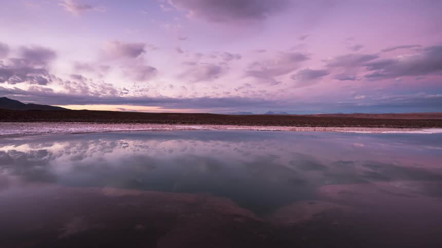 The clouds reflect on the shore line