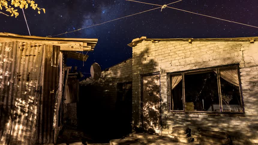 A white brick house and a night sky that is full of stars and time passes quickly