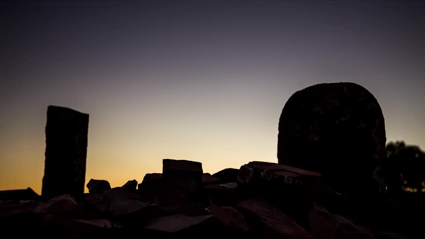 Metallic silver patterns on stones glow as the sunset and night falls