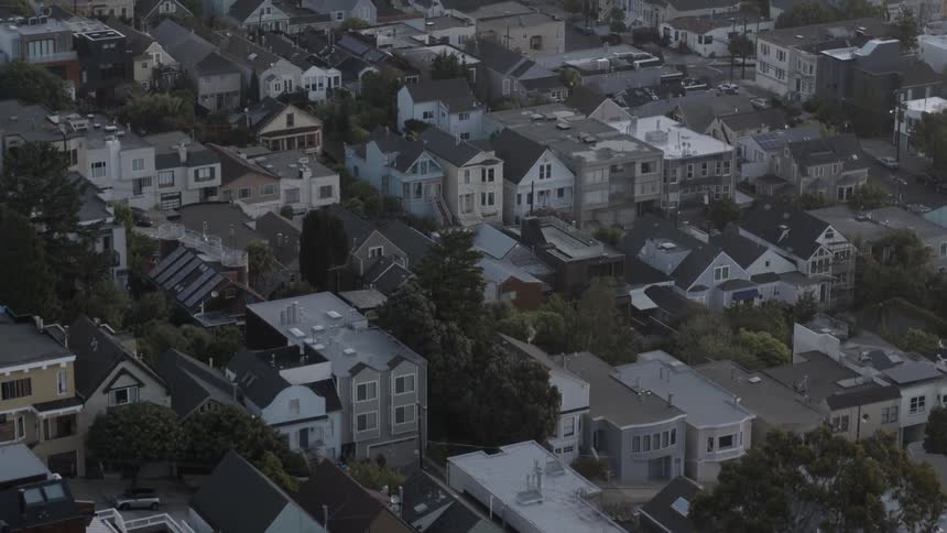 Moving over a town with many houses on a overcast day