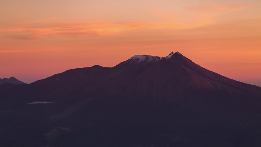 The sun sets on the large mountain range