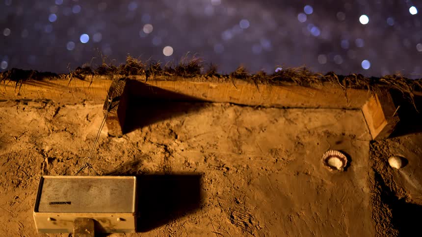 Dusty outpost under a spinning starry sky
