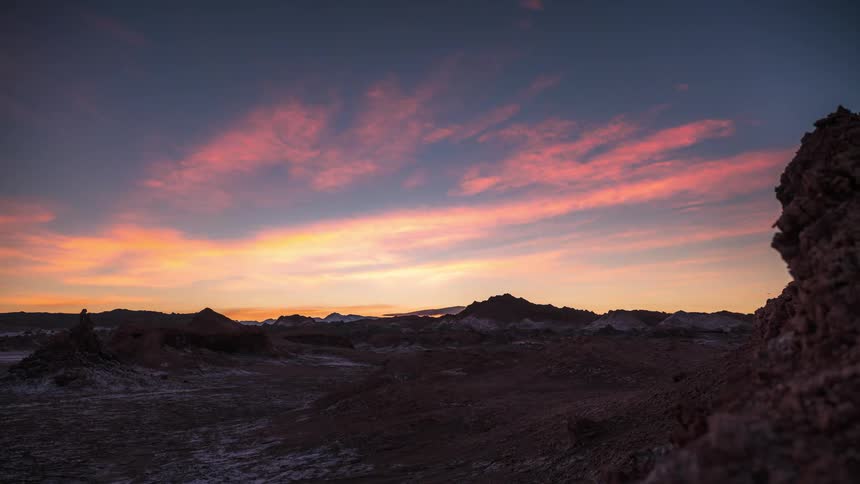 Time lapse of sunrise over a rugged desert landscape