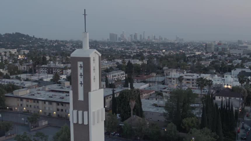 Aerial view of a church tower before a large city