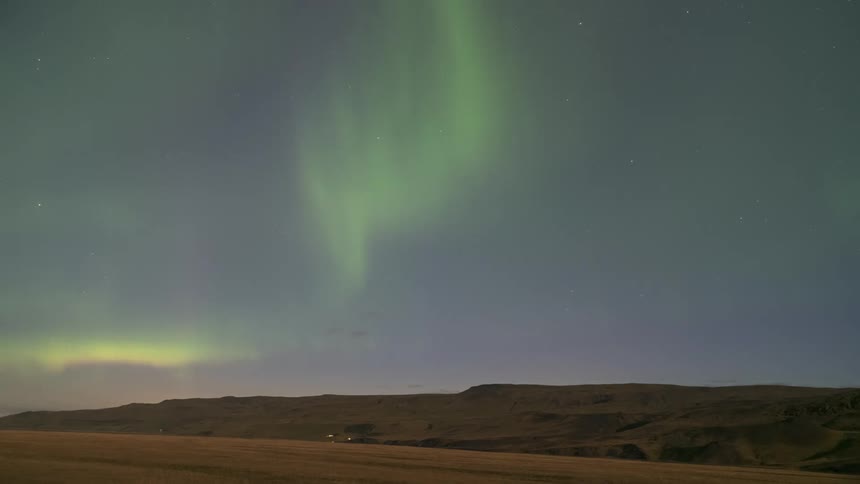 Mountains scenery in a night sky with northern lights