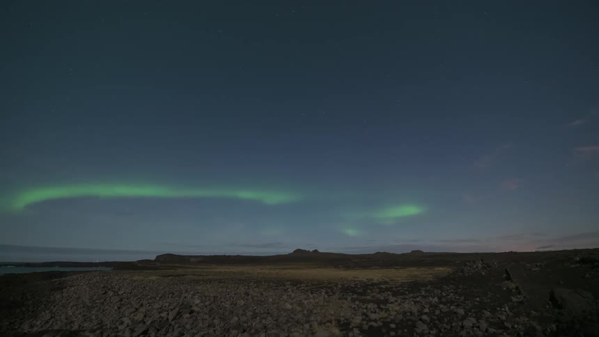 The green aurora shines in the sky