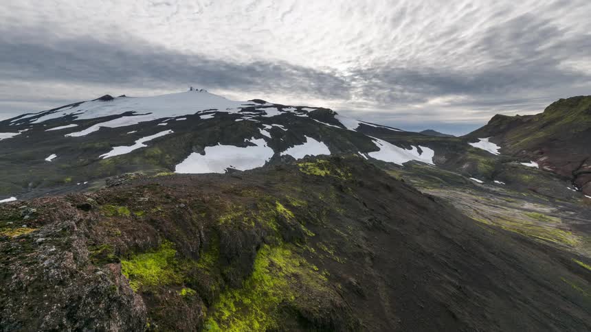 Sea of stormy clouds above snowy mountains in a daytime landscape