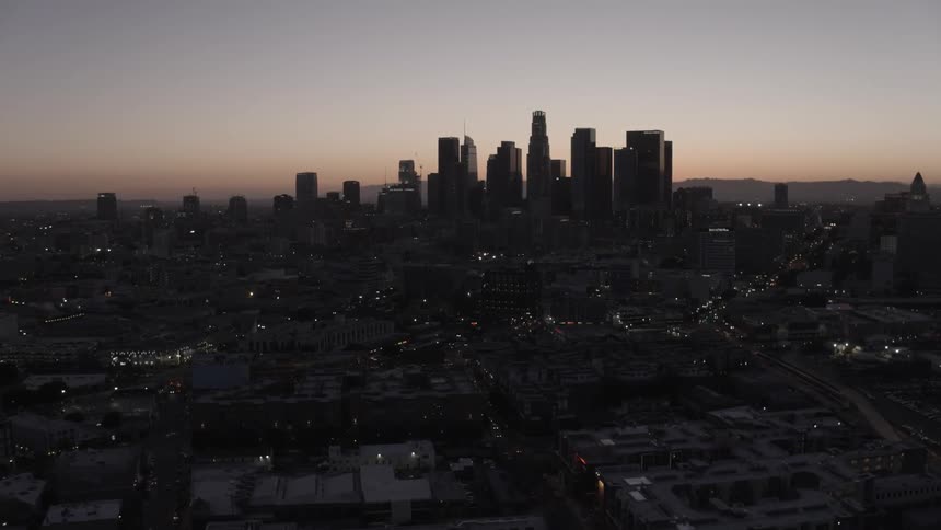 The sun is setting behind the city ahead