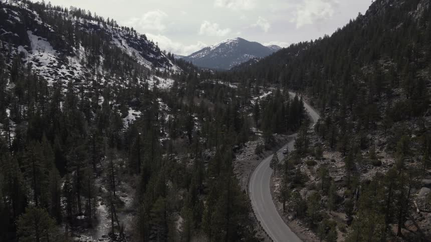 Aerial view of a roadway  winding through a mountainous area