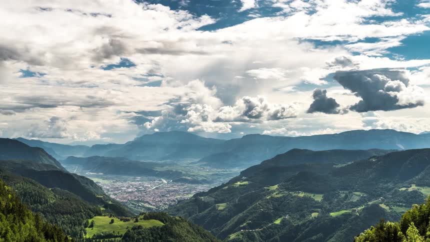 Natural and greenish scenery with a mountainous valley and partly cloudy sky