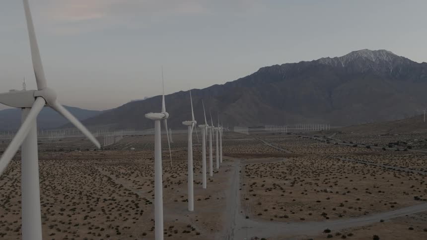 Row of wind turbines in the middle of the desert