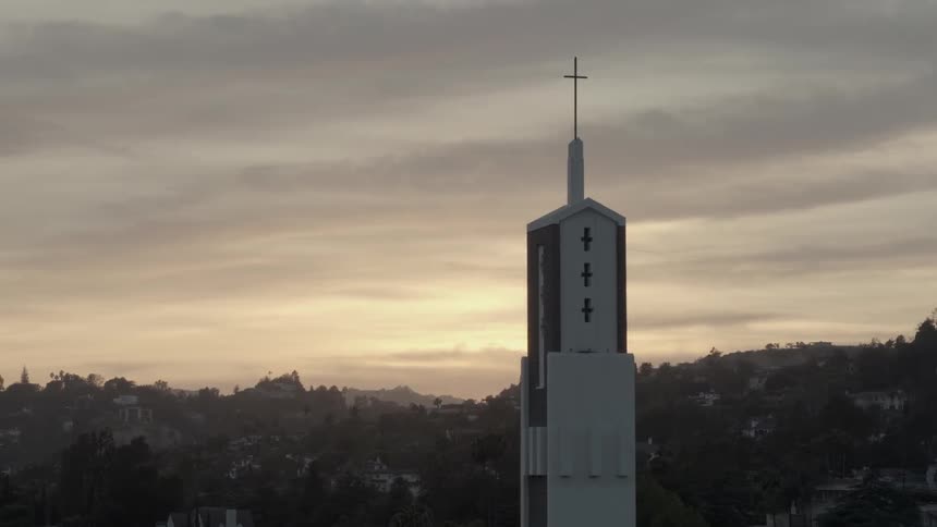 Aerial view of a church tower before a cloudy sunset