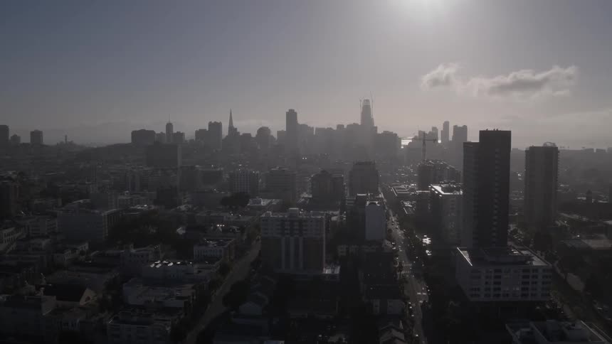 Aerial view of a large city with a hazy atmosphere