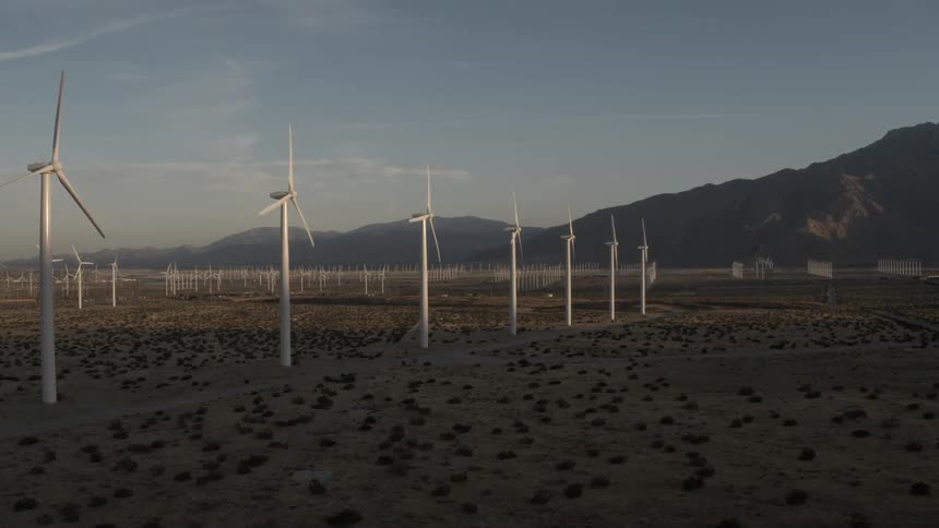A view of several spinning windmills in a field