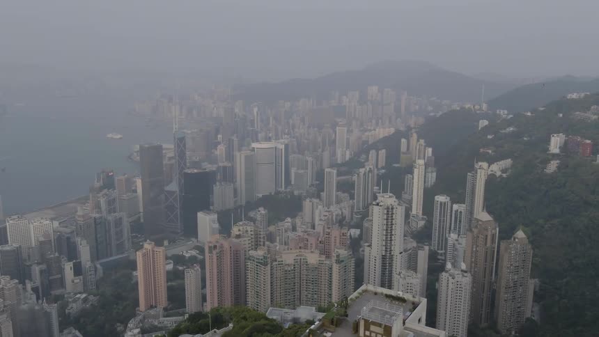 The coastal city is covered with fog on this hillside