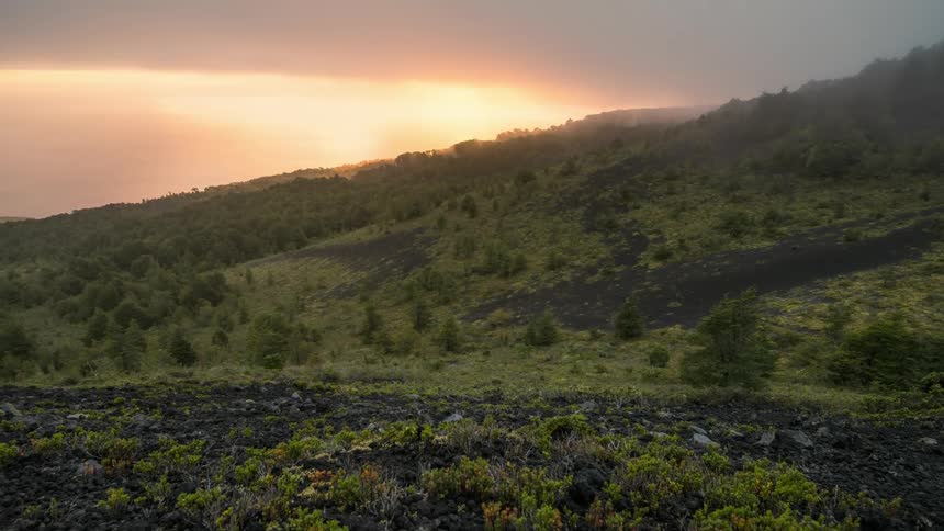 Time lapse of fog or mist rolling over the mountains at dusk