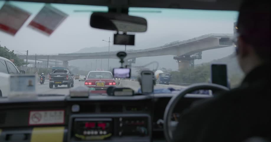 A man is driving down a crowded freeway