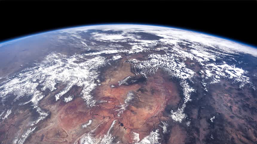 View of earth from space showing the curvature of the planet against dark space