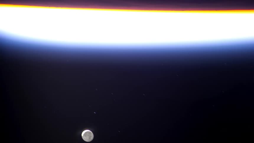 The moon sets as light fills the screen