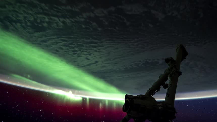 A telescope floats in space above the planet