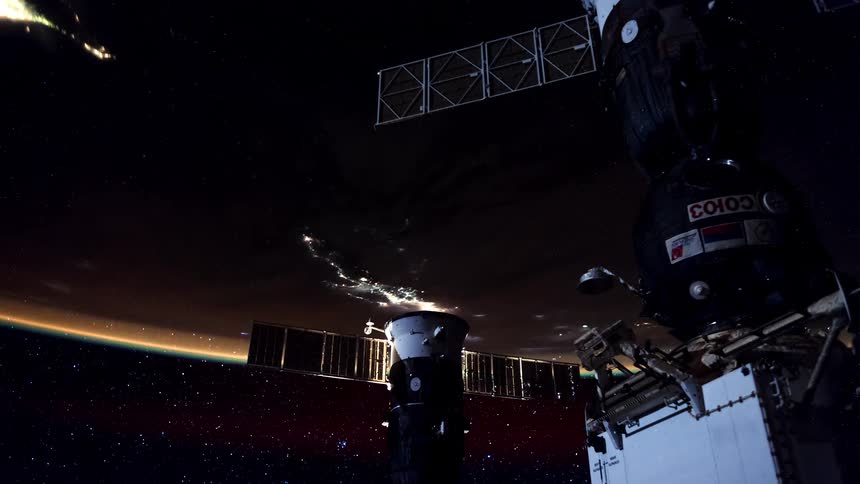 View of earth from space illuminated against the vast dark