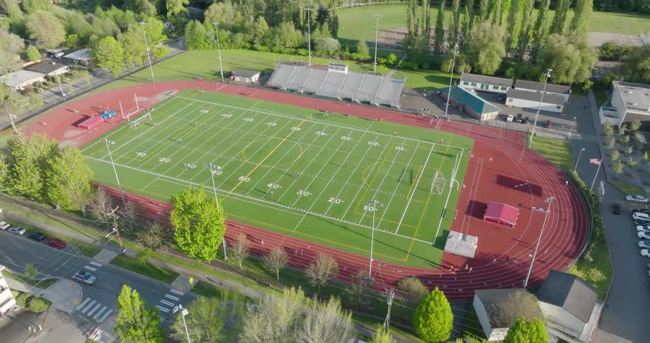 Athletes run and warmup prior to the start of a track and field competition
