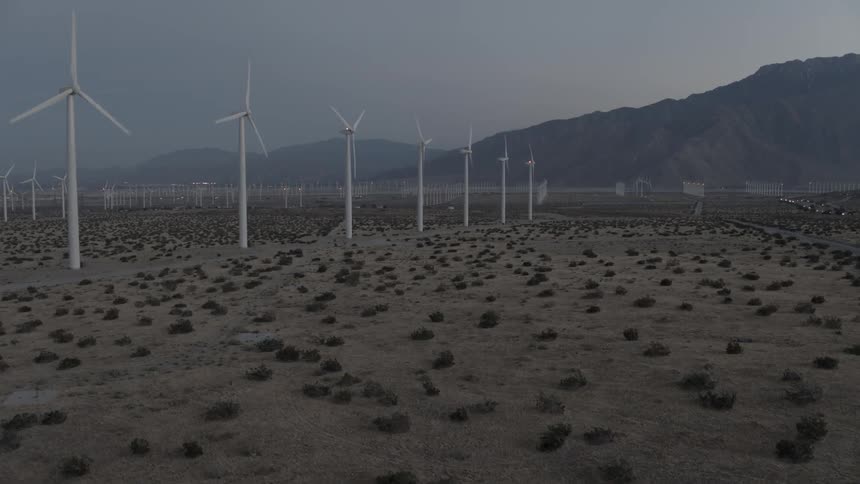 Rows of wind turbines rotating in the wind