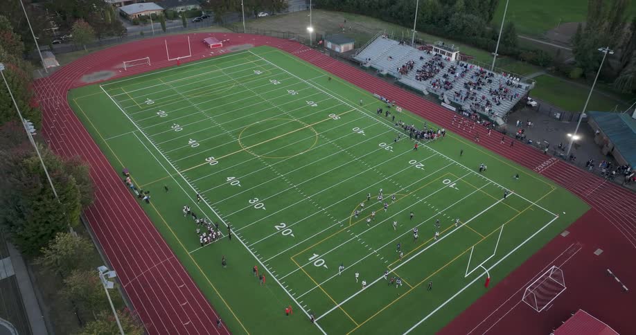 A player scores a touchdown during a Friday night high school football game