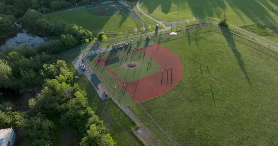 The batter gets a base hit and RBI at a youth baseball game on a sun kissed ball field