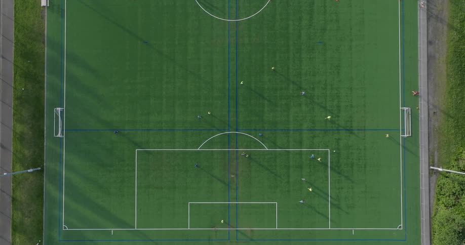 Top down view of gameplay in a youth league soccer match