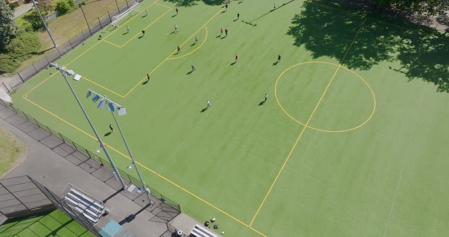 Slow traverse over people playing a pickup soccer game