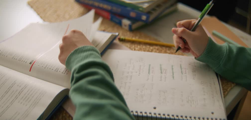A student is studying and reading a textbook