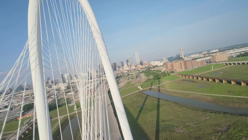 Cars are driving on Margaret Hunt Hill Bridge towards Dallas, Texas downtown