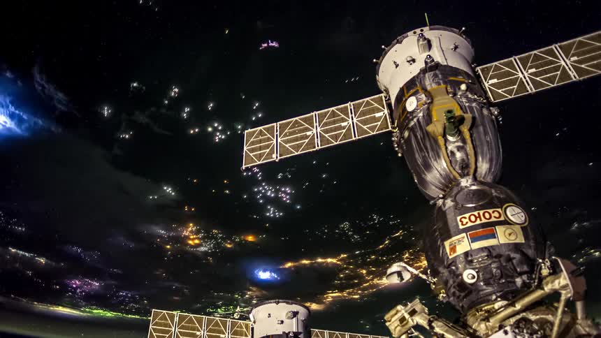 Satellite hovers over an active lit up earth
