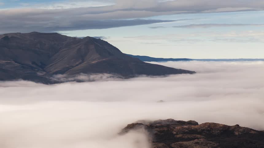 Clouds and fog are covering the mountainous landscape