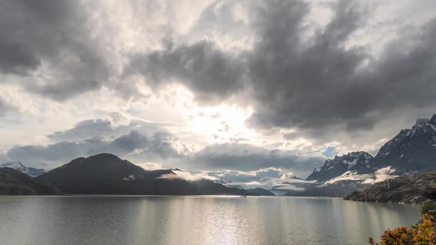 Time lapse of clouds rolling over a lake in the mountains
