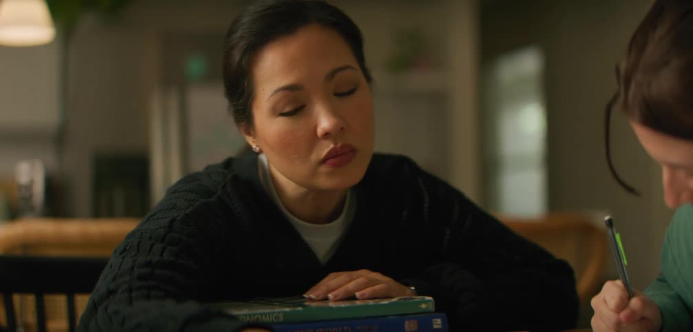 A teacher helping a student with homework at home