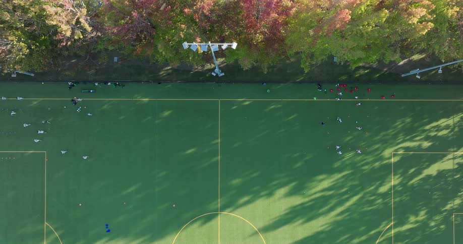 High school kids practice soccer drills on a late afternoon autumn day