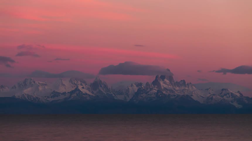 Time lapse view of the sun rising and setting above the mountains