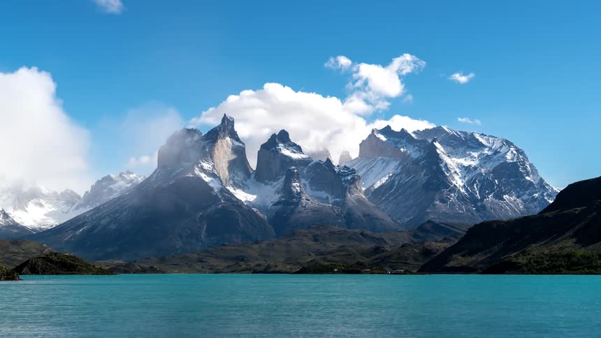 A blue lake is at the foot of the mountain