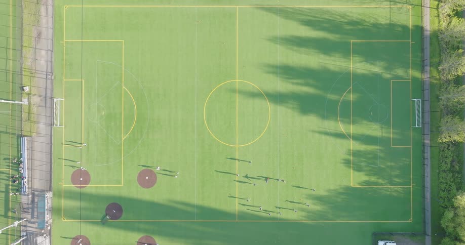 Top down view of little league players warming up before the start of their baseball game