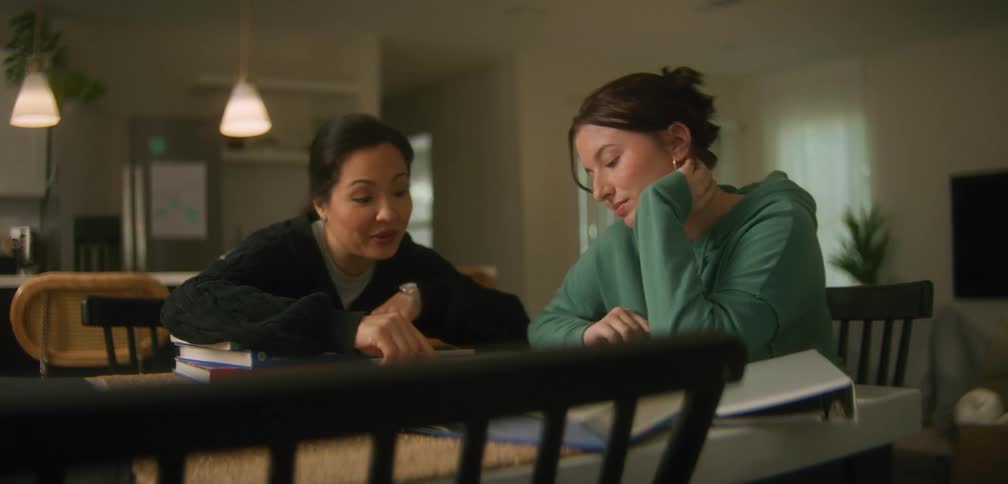 A tutor helps her student study discussing a lesson plan